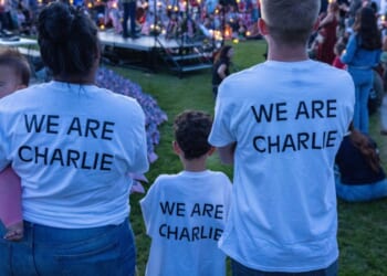 People wear shirts reading "we are Charlie" as they pay their respects to the late Charlie Kirk at a vigil in Provo, Utah, on Sept. 12, 2025.