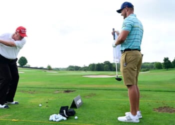 Donald Trump talks with Team Captain Bryson DeChambeau of Crushers GC on the practice range during the pro-am prior to the LIV Golf Invitational - Bedminster at Trump National Golf Club Bedminster in Bedminster, New Jersey, on July 28, 2022.