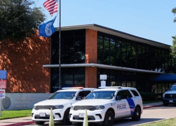Homeland Security personnel sit in their vehicles in front of the U.S. Immigration and Customs Enforcement office in Dallas, Texas, on Thursday.