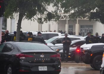 Law enforcement gather at a staging area close to a U.S. Immigration and Customs Enforcement office after a reported shooting, in Dallas, Texas, on Wednesday.