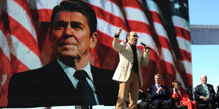 Lee Greenwood, center, sings at the centennial birthday celebration for former President Ronald Reagan at the Reagan Presidential Library in Simi Valley, California, on Feb. 6, 2011.