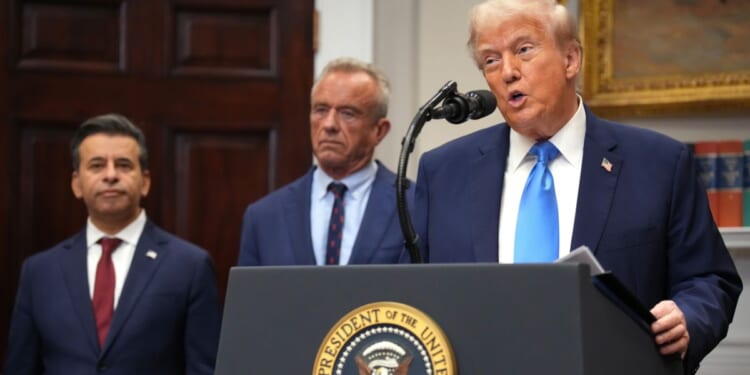 President Donald Trump, right, accompanied by Health and Human Services Secretary Robert F. Kennedy Jr., center, and Food and Drug Administration Commissioner Dr. Marty Makary, left, delivers an announcement on “significant medical and scientific findings for America’s children” in the Roosevelt Room of the White House in Washington, D.C., on Monday.