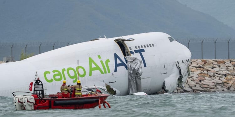 A cargo aircraft skids off a Hong Kong runway into the sea, killing two airport workers