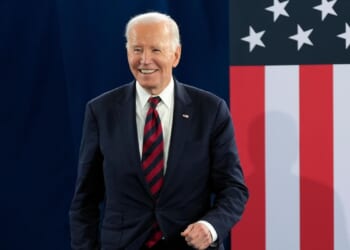 Ex-President Joe Biden rings the bell after completing radiation therapy for cancer