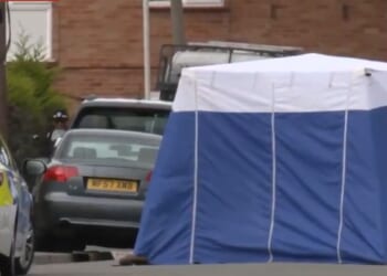 London police investigators set up a tent over the crime scene.