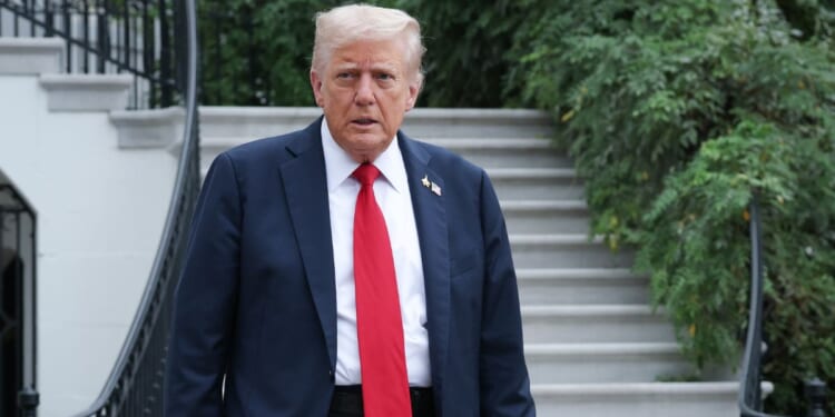 President Donald Trump walks toward members of the media before answering questions while departing the White House on Sept. 30, 2025, in Washington, D.C.