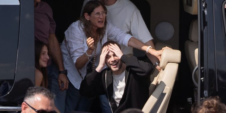 Former hostage Alon Ohel waves to supporters outside Beilinson Hospital in the Rabin Medical Centre in Petah Tikva, Israel, on Monday.
