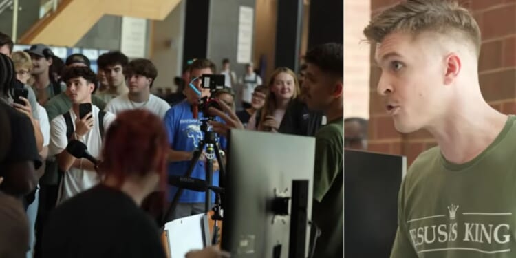 Joshua Haymes, right, took a sign saying "Christ Is King" with three points on it to begin a college debate tour in an effort to bring Christ back to students on campus.