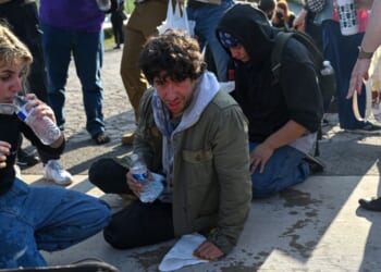 Demonstrators protesting outside the Immigration and Customs Enforcement facility, including Democratic congressional candidate Kat Abughazaleh, 26, react after being tear-gassed on Sept. 19, 2025, in Broadview, Illinois.