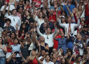 Attendees at a memorial service for Charlie Kirk sing worship songs before the beginning of the service in Glendale, Arizona, on Sept. 21.