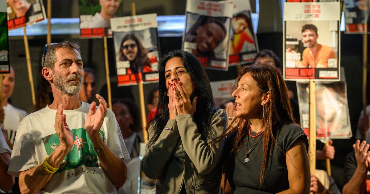 Einav Zangauker, mother of hostage Matan Zangauker, Ayelet Samerano, Ilan Dalal, father of hostage Guy Gilboa Dalal, stand on stage at a rally in Tel Aviv on October 11, 2025.