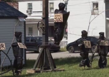 The display featured a gallows and several body bags with signs depicting the titles of local government officials.