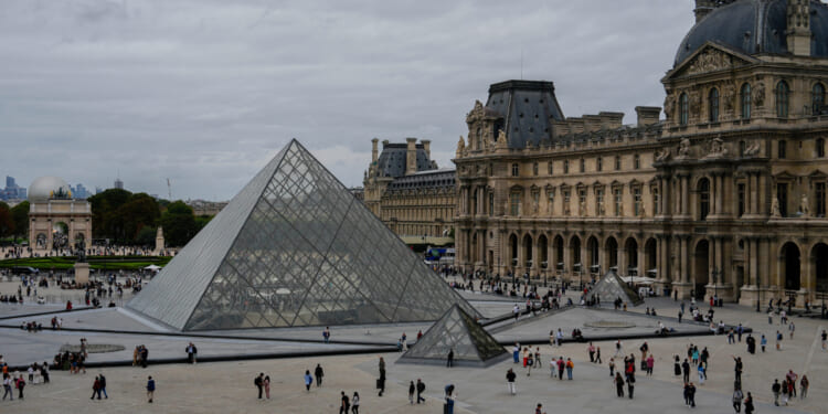 People walk outside the Louvre museum in Paris, France, on Aug. 31.