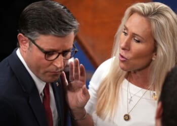 House Speaker Mike Johnson of Louisiana, seen with fellow Republican Rep. Marjorie Taylor Greene of Georgia in a January photo, clashed over the government shutdown during a conference call Tuesday.