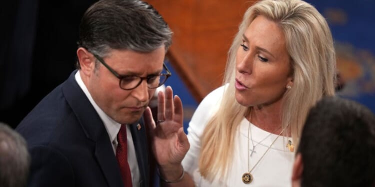 House Speaker Mike Johnson of Louisiana, seen with fellow Republican Rep. Marjorie Taylor Greene of Georgia in a January photo, clashed over the government shutdown during a conference call Tuesday.