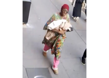This photo taken from surveillance video footage provided by the New York Police Department, shows a woman who is wanted for questioning after an infant girl was abandoned at a New York City subway station Monday.