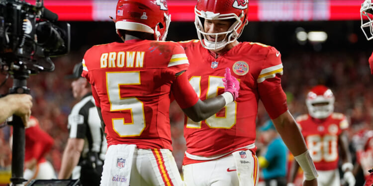 Kansas City Chiefs wide receiver Hollywood Brown is congratulated by quarterback Patrick Mahomes after scoring during the second half of an NFL football game against the Detroit Lions on Oct. 12, 2025, in Kansas City, Missouri.