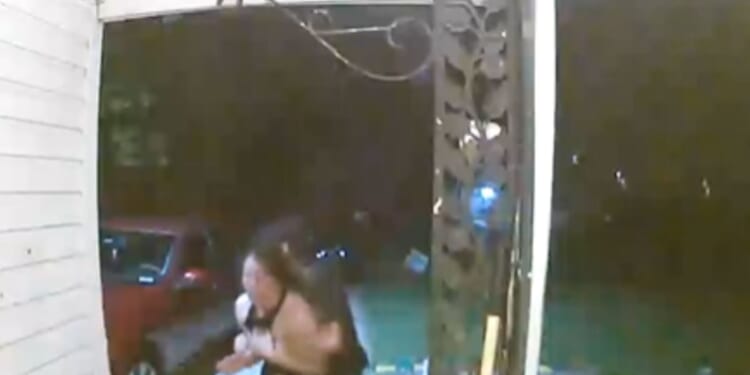 A woman appears to be abducted in Wichita, Kansas, as shown in footage posted by the Wichita Police Department on Oct. 13, 2025.