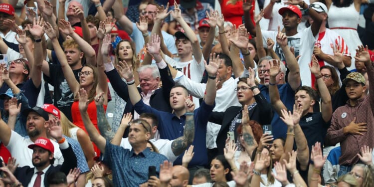 Attendees sing worship songs prior to the start of a memorial service for Charlie Kirk in Glendale, Arizona, on Sept. 21.