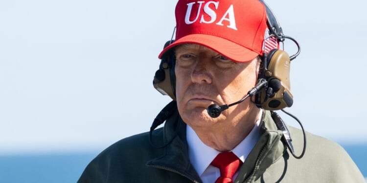 President Donald Trump visits the USS George H.W. Bush aircraft carrier near Norfolk, Virginia, as part of the U.S. Navy's 250th anniversary celebration on Sunday.