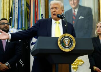 President Donald Trump, center, speaks to reporters during a news conference in the Oval Office of the White House in Washington, D.C., on Wednesday.