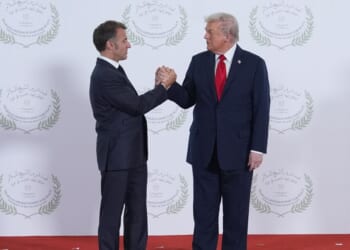 President Donald Trump greets France's President Emmanuel Macron during a summit of European and Middle Eastern leaders on Oct. 13, 2025, in Sharm El Sheikh, Egypt.