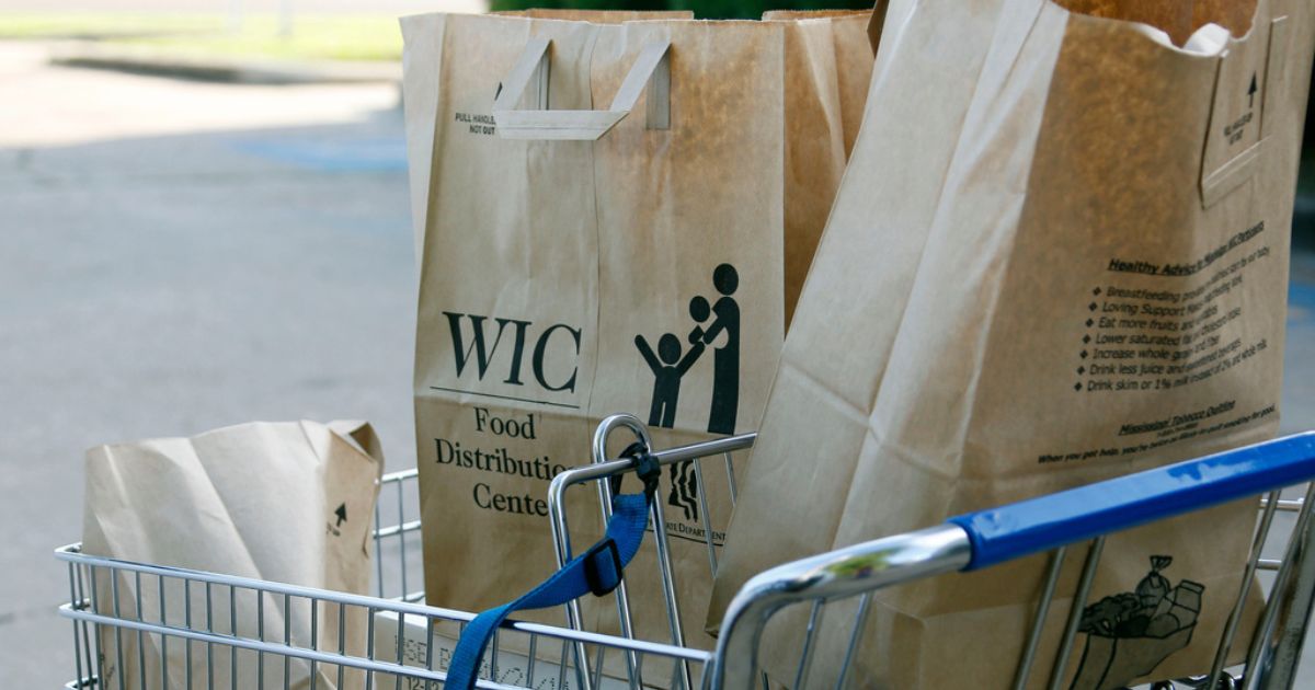 Grocery bags with food from the Special Supplemental Nutrition Program for Women, Infants and Children, WIC, sit in a shopping cart before being loaded into a vehicle in Jackson, Mississippi, on Oct. 3, 2013.