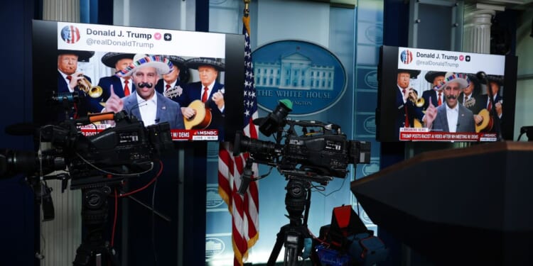 Screens display AI-modified videos of House Minority Leader Hakeem Jeffries and Senate Minority Leader Chuck Schumer that were shared on social media by President Donald Trump in the Brady Press Briefing Room at the White House in Washington, D.C., on Wednesday.