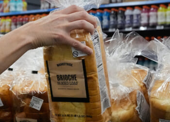 A customer reaches for a loaf of Marketside brand bread at a Walmart Neighborhood Market in Bentonville, Arkansas, on Friday.