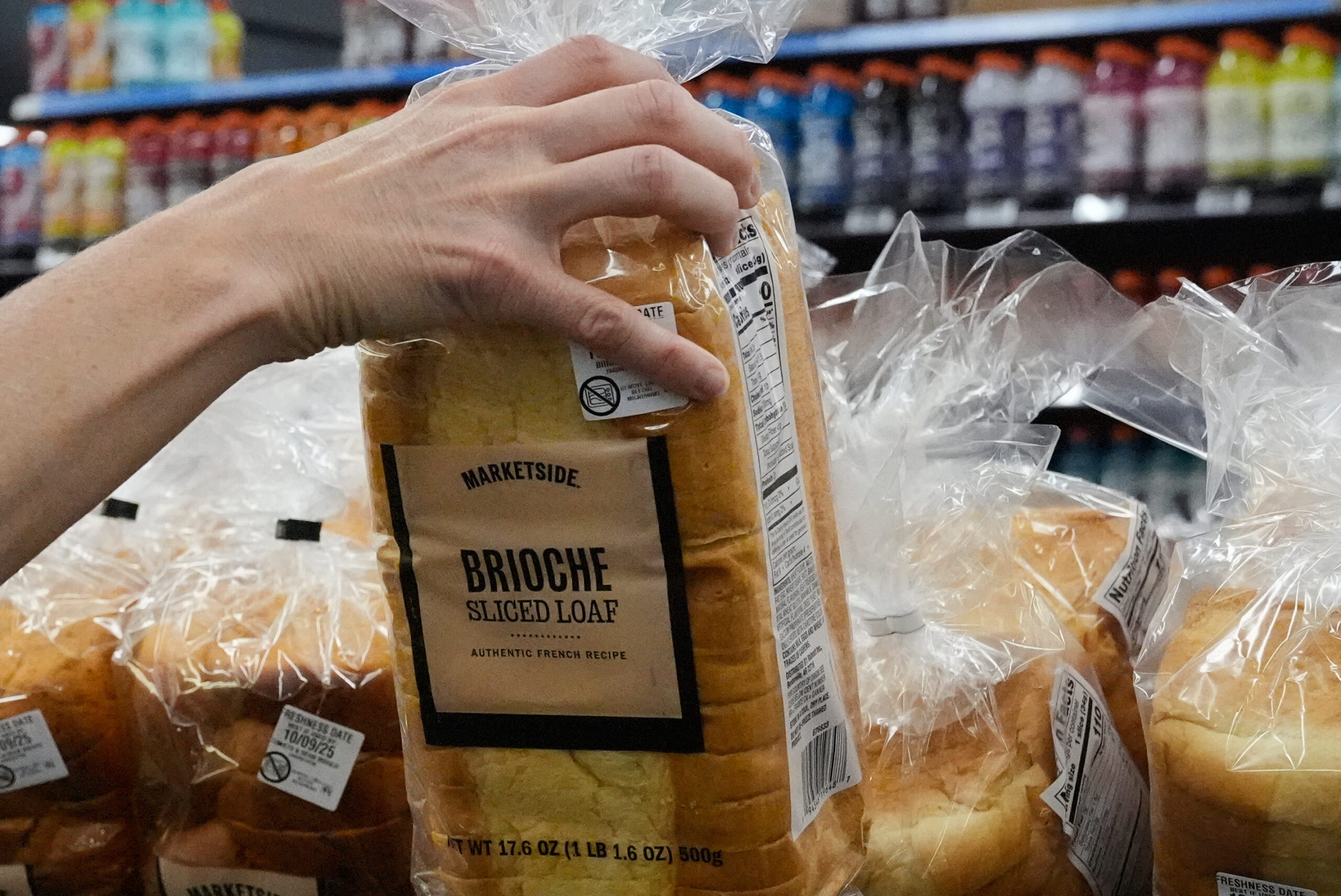 A customer reaches for a loaf of Marketside brand bread at a Walmart Neighborhood Market in Bentonville, Arkansas, on Friday.