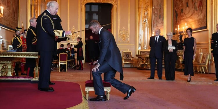 Bend a knee like David Beckham: Soccer star is knighted by King Charles III
