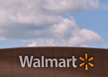 As Americans hunt for deals in slower economy, Walmart raises profit expectations