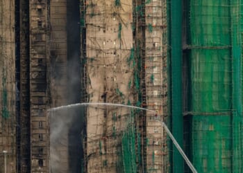 Hong Kong towers burn for a second day, at least 65 reported dead, hundreds missing