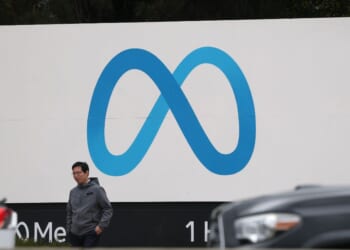 A visitor stands by a sign posted in front of Meta headquarters on Jan. 29, 2025, in Menlo Park, California.