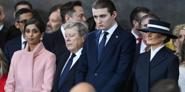 Barron Trump and Melania Trump look on during the inauguration ceremony in the US Capitol Rotunda in Washington, DC on Jan. 20, 2025.