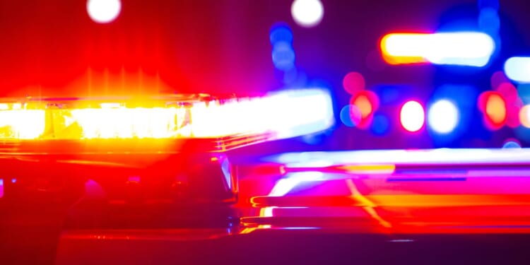 Red and blue flashing police lights at a crime scene.