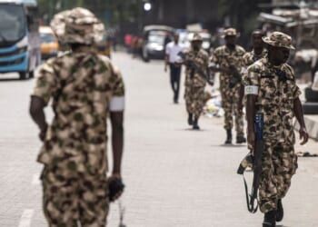 Soldiers from the Nigerian Armed Forces patrol and secure the streets in Lagos Island, Lagos, on Feb. 27, 2023, after hoodlums had harassed market owners.