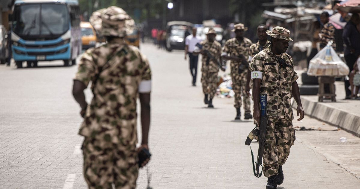 Soldiers from the Nigerian Armed Forces patrol and secure the streets in Lagos Island, Lagos, on Feb. 27, 2023, after hoodlums had harassed market owners.