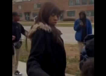 A woman is surrounded by attackers in Chicago on Monday.