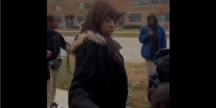 A woman is surrounded by attackers in Chicago on Monday.