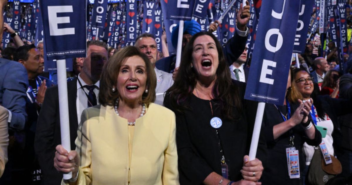 Former House Speaker Nancy Pelosi, left, and her daughter Christine Pelosi hold "We Love Joe" signs in a file photo from Aug. 19, 2024, as then-President Joe Biden spoke on the first day of the Democratic National Convention in Chicago, Illinois.