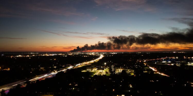 Smoke rises from the site of a UPS cargo plane crash near the UPS Worldport at Louisville Muhammad Ali International Airport in Louisville, Kentucky, on Nov. 4, 2025.