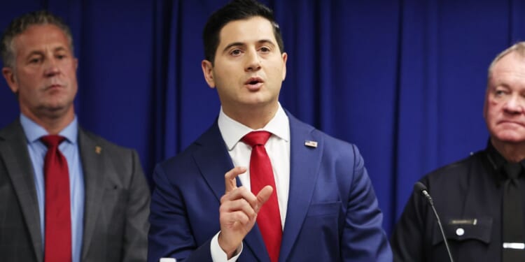 Acting U.S. Attorney Bill Essayli speaks as Los Angeles Police Department Chief Jim McDonnell and Special Agent in Charge Kenny Cooper of the Bureau of Alcohol, Tobacco, Firearms and Explosives, Los Angeles Field Division, look on at a press conference announcing an arrest in the Palisades Fire investigation on Oct. 8, 2025, in Los Angeles, California.