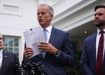 Senate Majority Leader John Thune holds a copy of a funding bill as he delivers remarks following a meeting with Congressional Democrats and President Donald Trump at the White House on Sept. 29, 2025, in Washington, D.C.