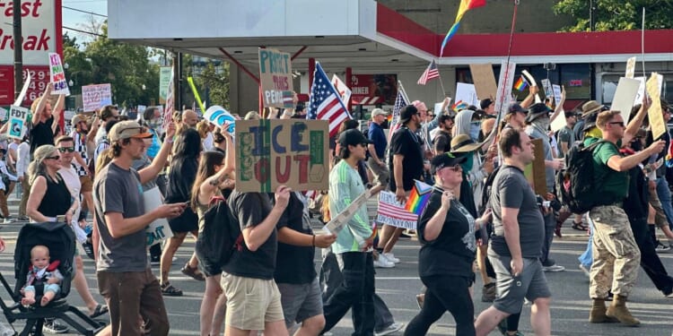 Safety volunteer charged in the fatal shooting of a Utah 'No Kings' protester