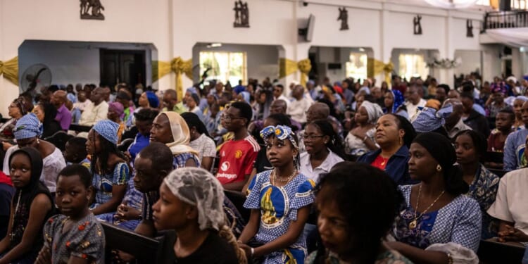Nigerian Catholics gather for mass at the Church of Assumption in Lagos on April 21, 2025.