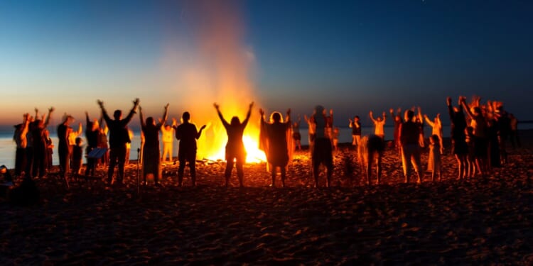 People celebrate the Night of Ancient Bonfires, a tradition practiced along the Baltic coast with Pagan roots.