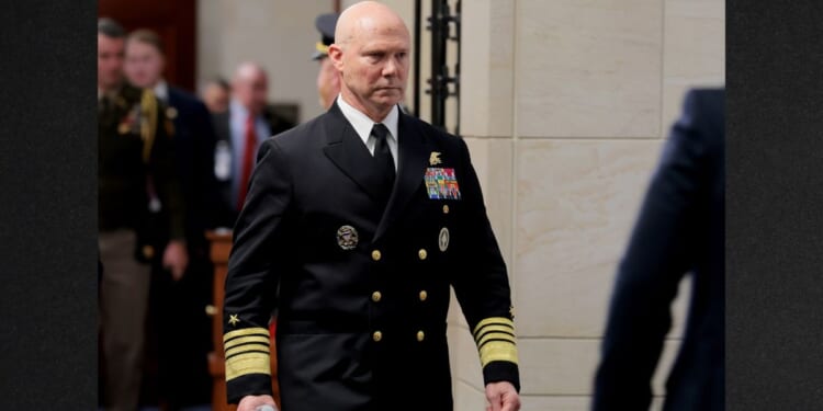 Navy Adm. Frank Bradley walks to a hold room between closed-door classified meetings with lawmakers on Capitol Hill on Thursday in Washington, DC. Members of the Senate and House Armed Services committees met with Bradley about the strikes on suspected drug boats out of Venezuela ordered by the Trump Administration.