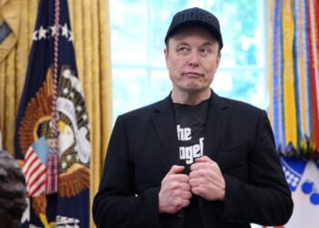 Elon Musk stands in the Oval Office of the White House as President Donald Trump speaks to reporters in Washington, DC on May 30, 2025.