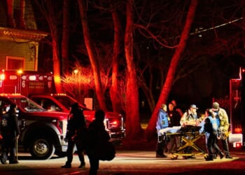 First responders with the Providence Fire Department maneuver an empty stretcher near the Barus and Holley building, home to the engineering and physics departments and the site of a mass shooting, at Brown University campus in Providence, Rhode Island, on Dec. 13, 2025.